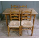 A reproduction pine kitchen table of rounded rectangular form, 152cm long x 76cm wide; together with