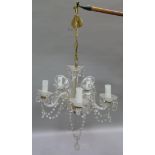 A ten branch moulded glass hanging chandelier, hung with prismatic pendants