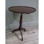 A George IV mahogany topped tripod table with elm column, top 55cm diameter