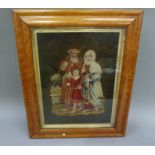 A Victorian needlework picture of couple and child in landscape worked in gros and petite pois, gilt