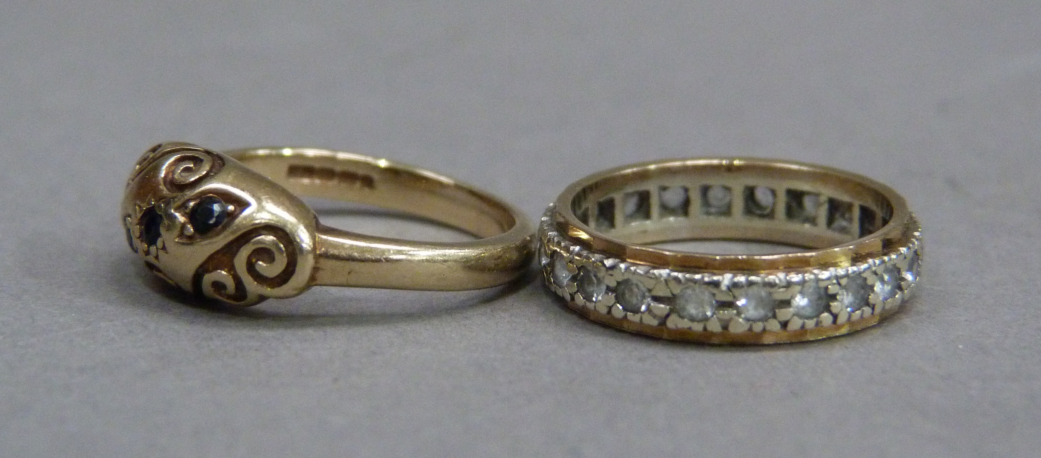 Two 9ct gold rings, a three stone sapphire ring and a colourless spinel eternity ring, total - Image 2 of 2