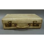 A cream parchment small suitcase with British brass lever locks, 40cm wide