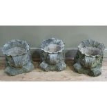 A set of three reconstituted concrete shell planters, each supported on a scrolling corbel, 35cm x