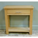 A reproduction oak single drawer side table with undertier, 76cm wide