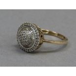 A diamond cluster ring in 9ct gold, the eight-cut stones set to the centre, raised against a
