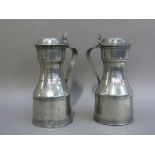 A pair of pewter tappit hens of conventional form with reeded bands, domed covers with