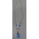 An Austrian crystal necklace by Enbura gold, in blue and colourless faceted beads on a fine