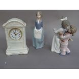 Two Nao figures numbers 1120 and 1122, together with a Belleek fine Parian china mantel clock
