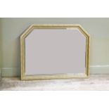 A reproduction gilt over mantel mirror of geometric arched form with bevelled plate within beaded