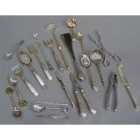 A quantity of silver plated decorative cutlery including asparagus servers, nutcrackers, sifter