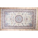 A Caucasian style multicoloured bordered rug, the cream field decorated overall with flowerheads and