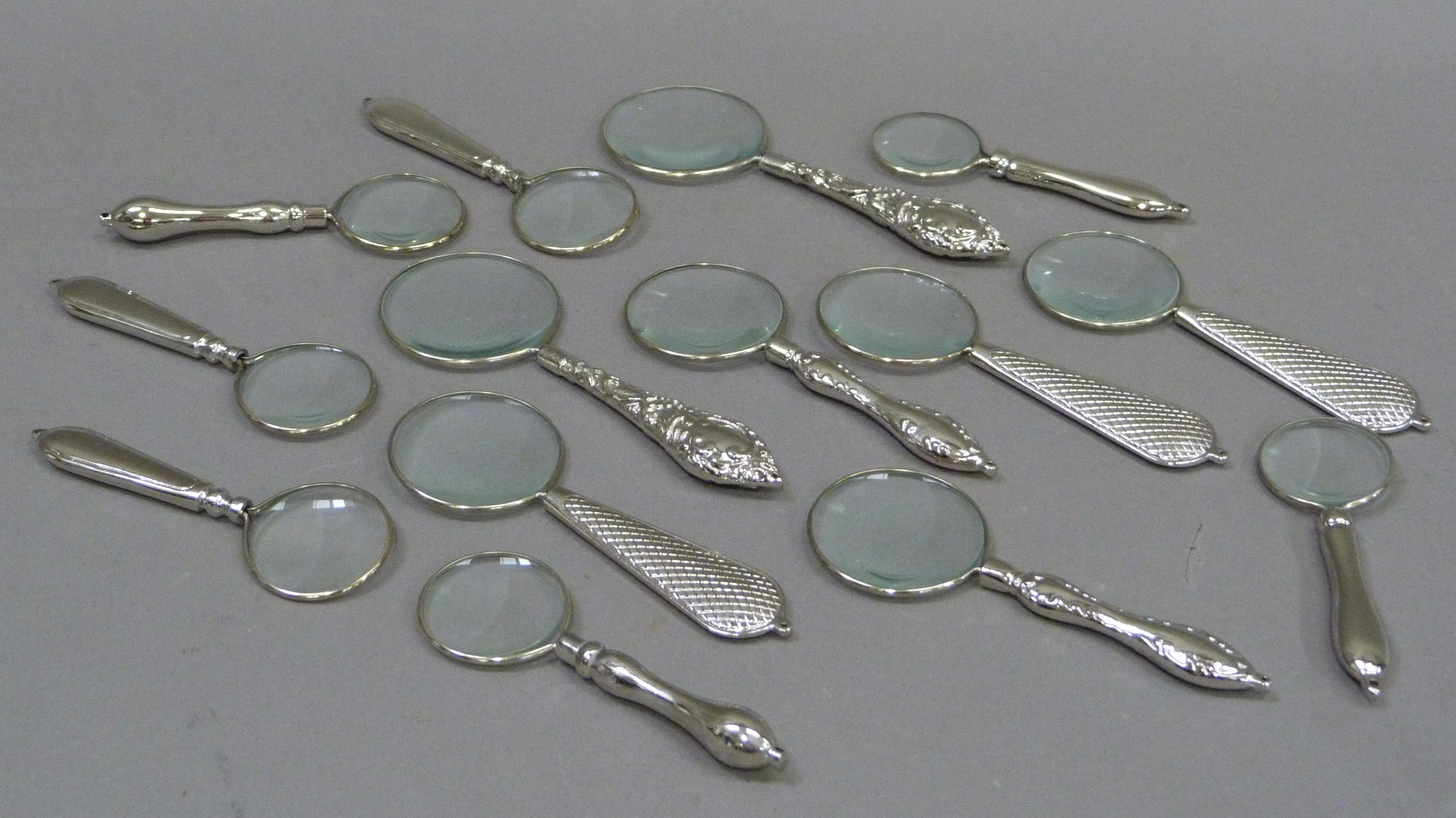 A quantity of magnifying glasses with decorative handles