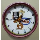 A retro Esso wall clock, the face printed with tiger and inscribed: Put a Tiger in your Tank,