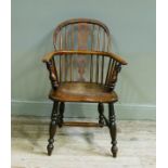 A mid 19th century ash and elm low back Windsor elbow chair with pierced splat, dished ordered