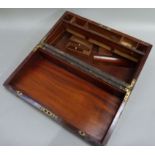 A mid 19th century brass bound mahogany writing slope, the hinged lid with vacant shaped angular