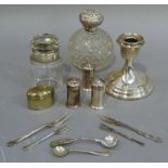 A quantity of silver items including, dwarf candlestick, three piece cruet, silver topped scent