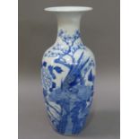 A Chinese porcelain baluster vase painted in underglaze blue with pheasant and butterflies amidst