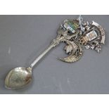 Three items of early to mid 20th tourist ephemera including a base metal Lews brooch, silver