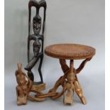 A hardwood circular table carved with flowers and leafage on folding stand; together with a quantity