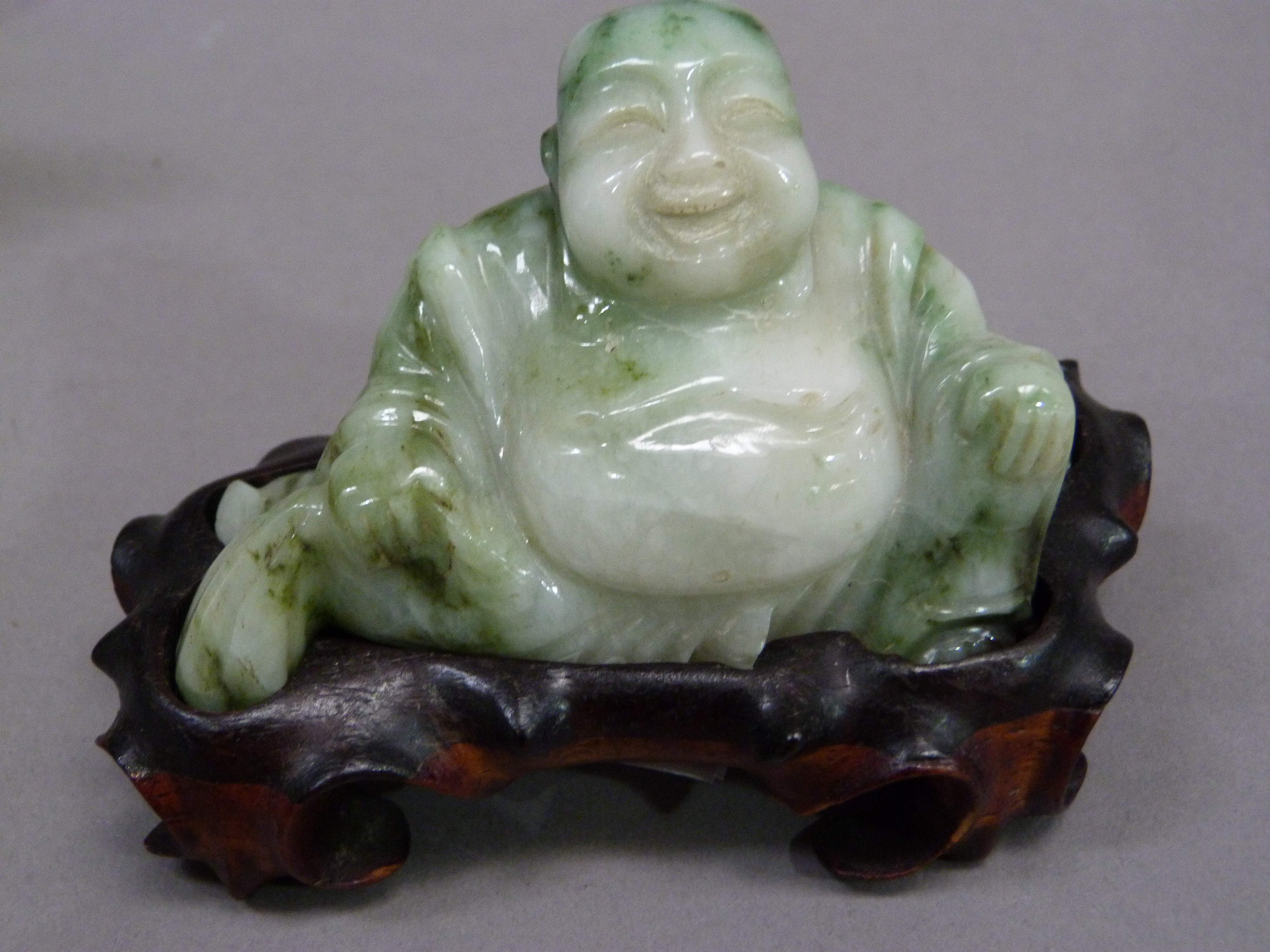A carved jadeite buddha on hardwood base, 7cm high; together with a brown soapstone carving of a - Image 3 of 5