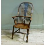 A late 19th century high back Windsor elbow chair with pierced splat, bordered seat on turned legs