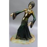 A reproduction Art Deco style bronze effect figure of a dancer, ivorine detail on faux onyx base,