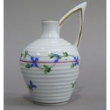A Herend miniature jug of ribbed form with high angular handle, painted with trailing blue