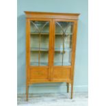 A Edwardian painted satinwood display cabinet with flared cornice, decorated frieze enclosed by a