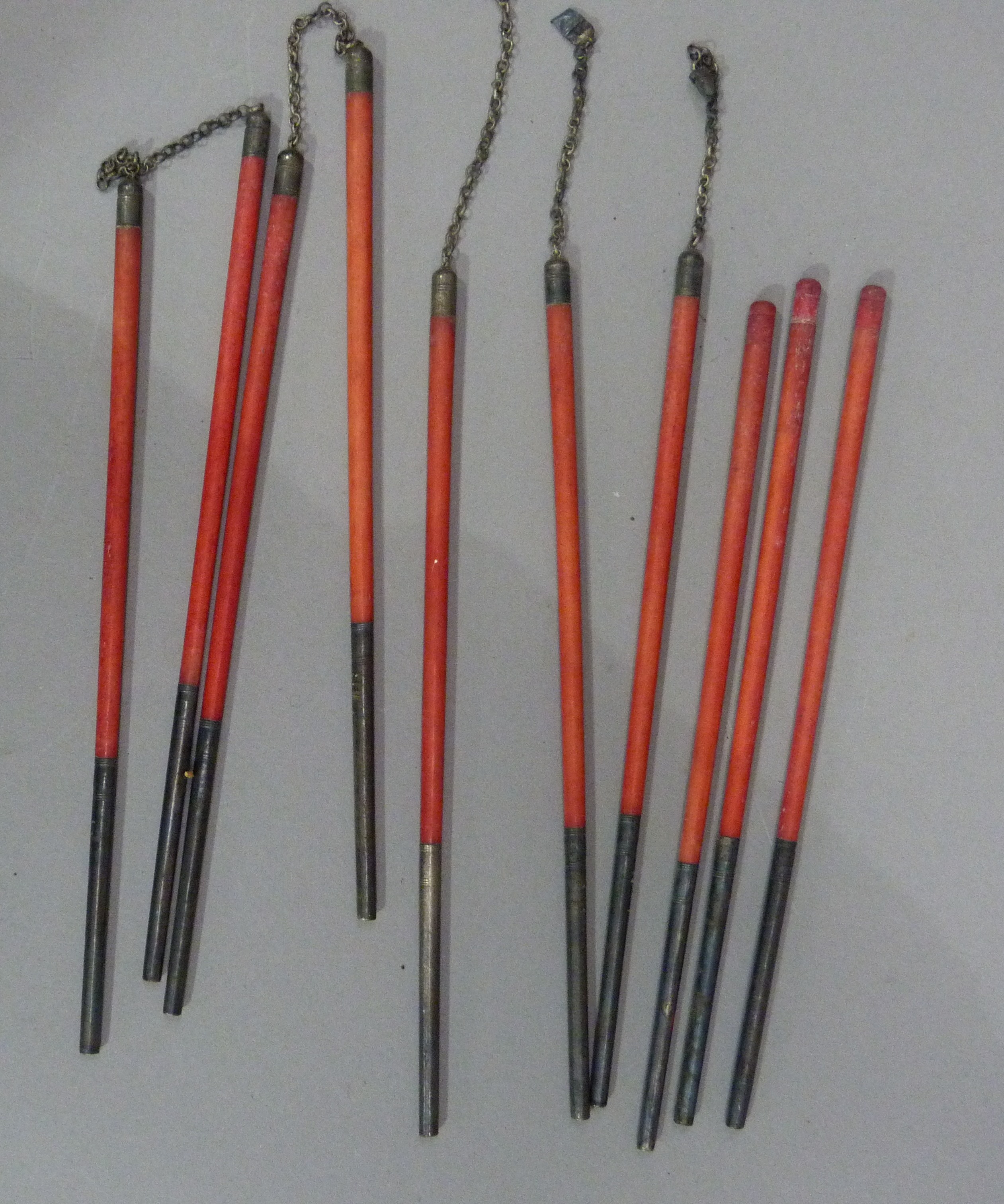 Five pairs of Chinese red-stained bone chopsticks, two pairs joined with chain links, all with