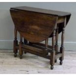 An oak gate-leg table, the oval top above turned legs joined by moulded square stretchers, 80cm wide
