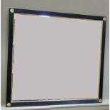 A Regency style overmantle mirror with ebonised reeded frame with gilt slip and circular embossed