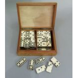 A set of bone dominoes in a wooden box