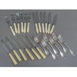 A quantity of fish knives and forks and dessert knives and forks with ivorine handles