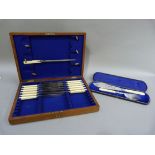 A pair of Victorian silver plated fish servers with pierced and engraved blades and ivory handles,