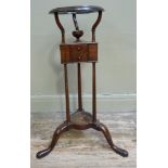 A mahogany wig stand of conventional form with open circular moulded top above powder compartment,