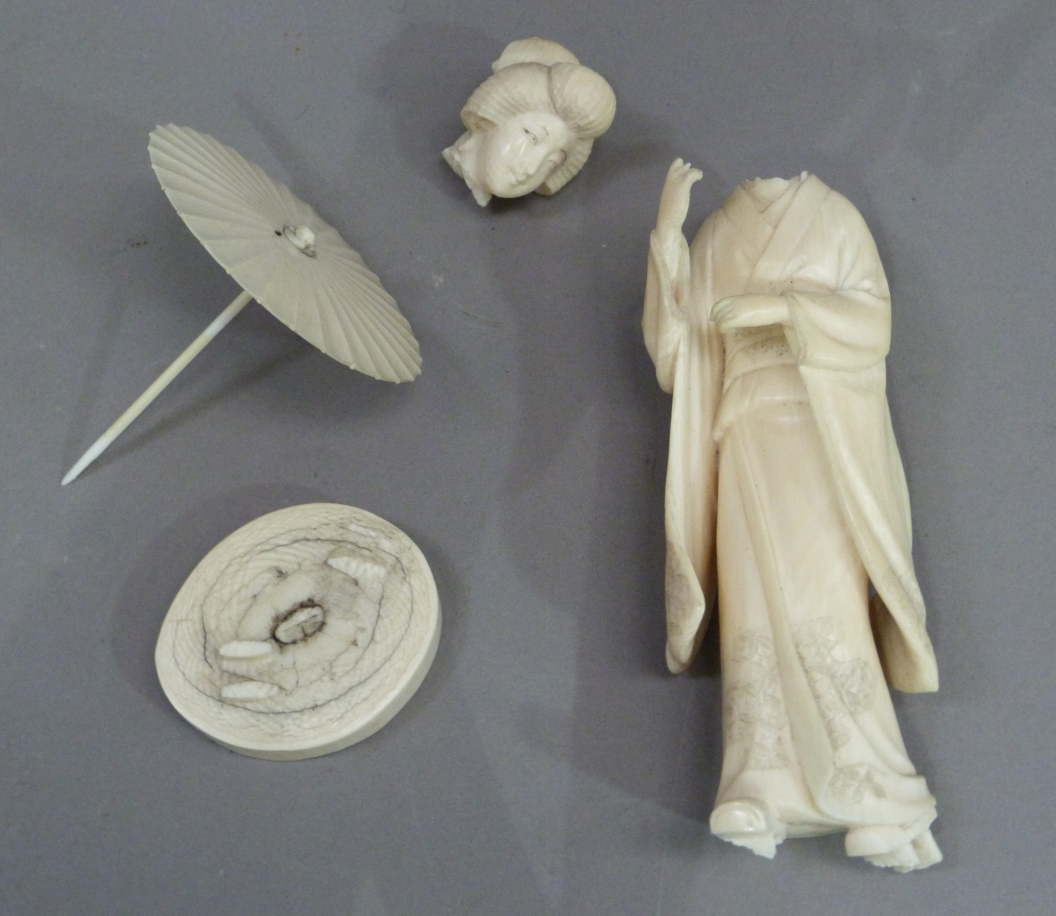 A Japanese figure of a bijin with parasol, Meiji period (broken)