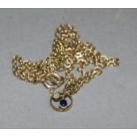 A George V sapphire and seed pearl pendant in 9ct gold hung on a later fine trace link chain in