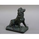 A green serpentine sculpture of a dog, 11cm wide x 12cm high