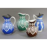 Four Victorian Brownfield coloured jugs, three in green blue and brown of the same pattern, one with