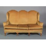 A Queen Anne style triple wing back sofa on squat cabriole legs with pad feet, 184cm wide, c1930's