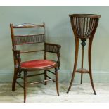 A late Victorian mahogany elbow chair, the serpentine cresting rail inlaid with urns and ribbon tied