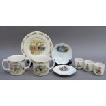 A Bunnykins mug, a two handled mug, three egg cups, a plate, together with two Peter rabbit saucers