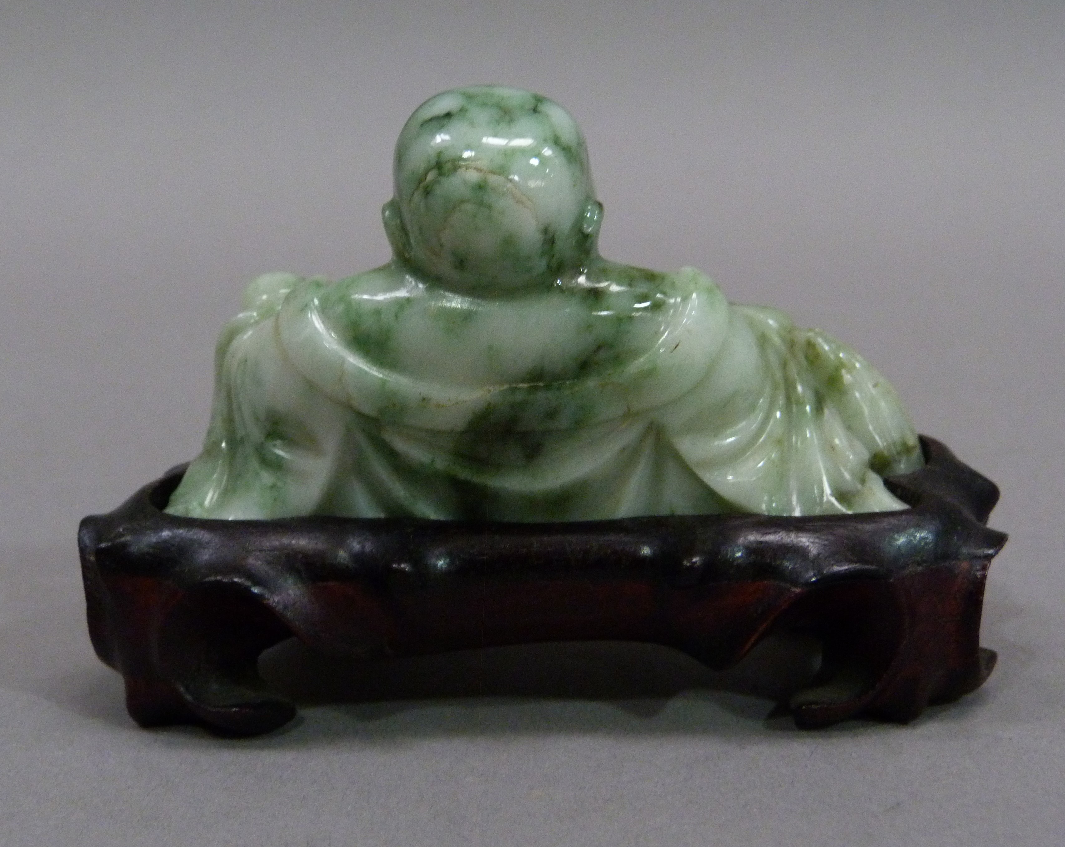 A carved jadeite buddha on hardwood base, 7cm high; together with a brown soapstone carving of a - Image 5 of 5