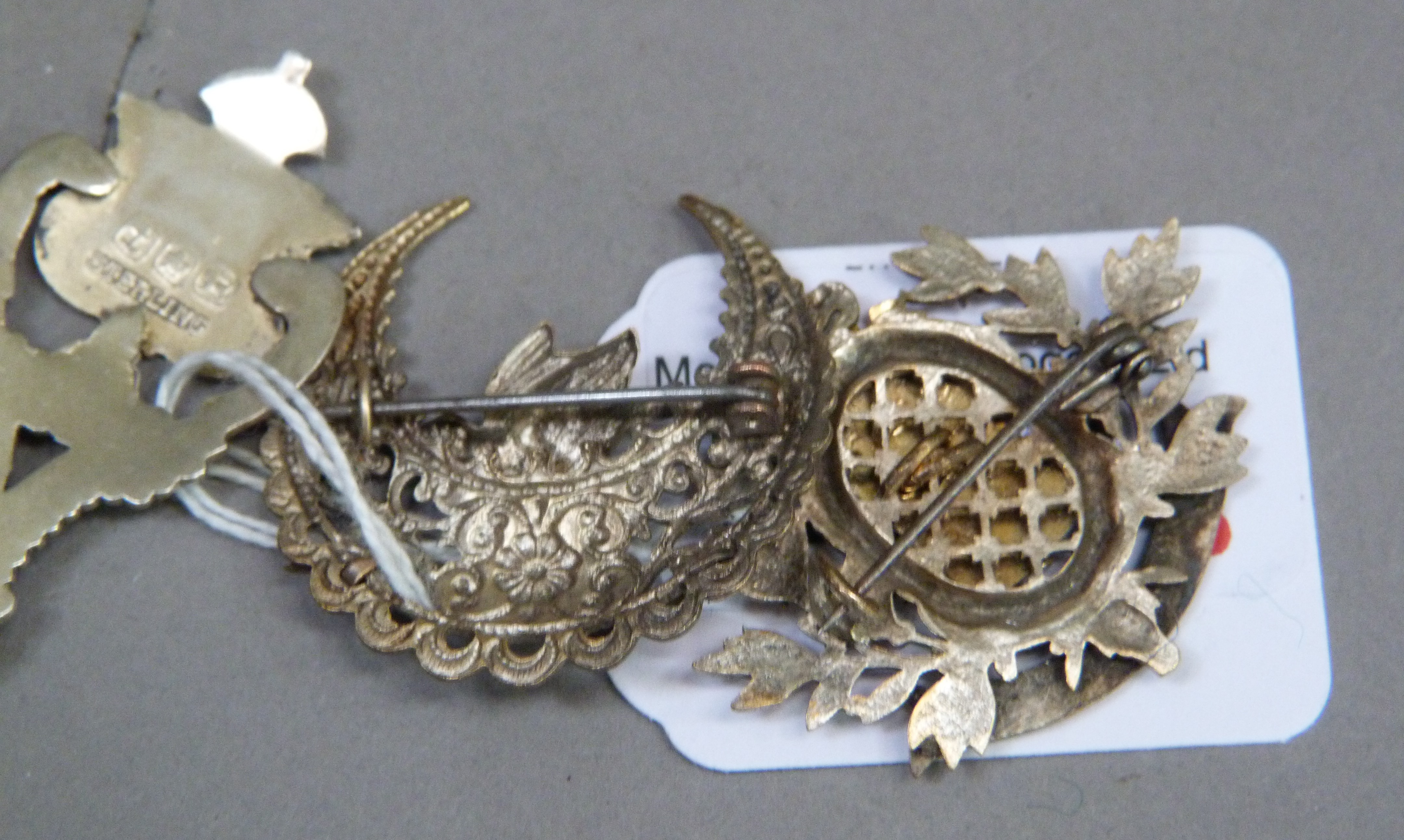 Three items of early to mid 20th tourist ephemera including a base metal Lews brooch, silver - Image 3 of 3