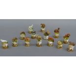 A collection of fourteen Sutherland bone china thimbles each mounted with a resin model of British