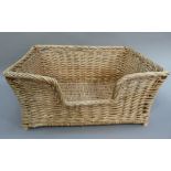 A wicker dog basket, 65cm wide