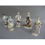A Sevres porcelain candlestick the rustic stump behind a woodsman and his companion by a brazier,