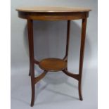 An Edwardian mahogany circular two tier occasional table on splayed square tapered legs with
