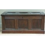 An old reproduction three panelled blanket chest with channelled frame, skirted plinth, 120cm wide