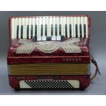 A Hohner Verd II accordion with chromium plated metal and simulated red mother of pearl case, 46cm